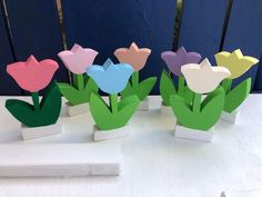 four paper tulips sitting on top of each other