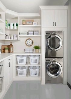 a washer and dryer in a laundry room with white shelving on the wall