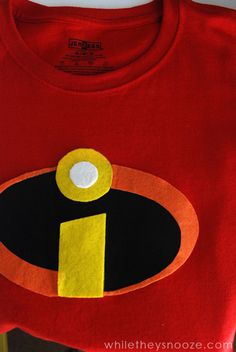 a red t - shirt with a yellow and black logo on it