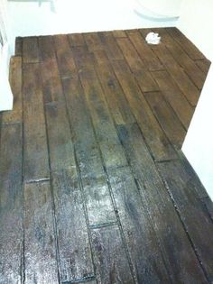 a bathroom with wood floors and white walls