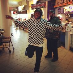 a man in a checkered sweater is dancing