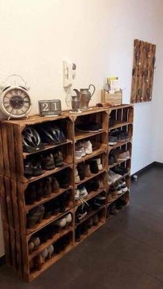 a wooden shelf filled with lots of shoes