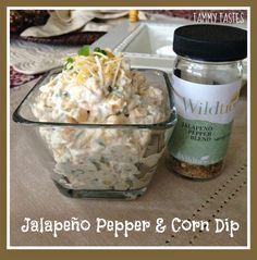 there is a bowl of food next to a jar of pepper and condiments