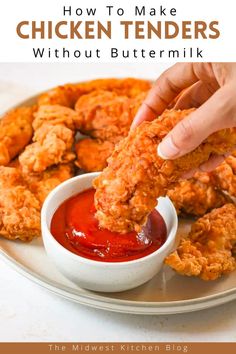 chicken tenders with buttermik being dipped into ketchup on a plate