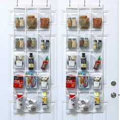 two clear doors with spices and condiments hanging on the side by hooks that are attached to them