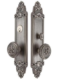 an ornate door handle with two knobs on the front and back of each door