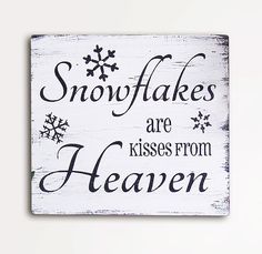 a wooden sign that says snowflakes are kisses from heaven on the side of a shelf