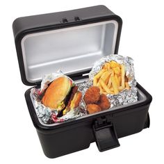 an open lunch box with two sandwiches and fries