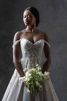 a woman in a wedding dress holding a bouquet