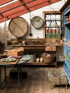 an old fashioned kitchen with lots of pots and pans