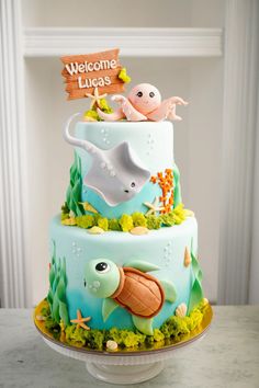 a three tiered cake decorated with sea animals