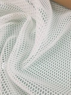 a close up view of a white netted fabric