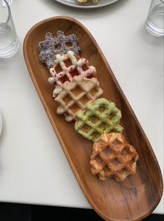 waffles and other pastries on a wooden plate