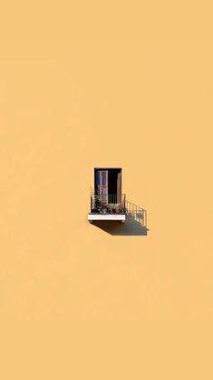 an apartment building with balcony and balconies on the top floor against a pale yellow background