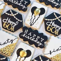 black and white decorated cookies with gold decorations on them for a 60th birthday party or celebration