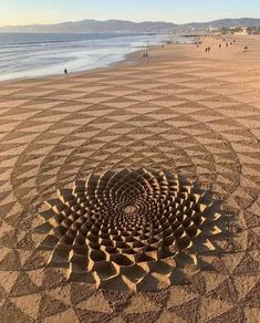 an intricate sand art work on the beach