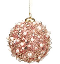 a pink ornament with pearls hanging from it's side on a gold chain