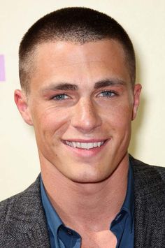 a man in a suit and blue shirt smiling for the camera at an awards event