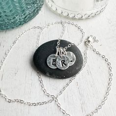 Sterling silver keepsake Initial necklace. Small circle charms are textured and stamped with the letters that mean the most to your heart. Add your initials in the order notes box at checkout. Solid sterling silver charms 1/4 wideSterling silver cable chain.