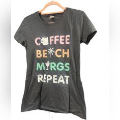 Brand New With Out Tags Graphic Tee Coffee Beach Marg Repeat Tee Size M Cery Soft Tee Black Short Sleeve Top For Beach Season, Black Graphic Tee For Vacation, Black Graphic Print Vacation Top, Black Graphic Print Top For Vacation, Black Crew Neck Top For Beach Season, Black Letter Print T-shirt For Beach Season, Black Text Print T-shirt For Vacation, Black Text Print Top For Vacation, Black Text Print Tops For Vacation