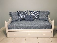 a blue and white couch with pillows on it