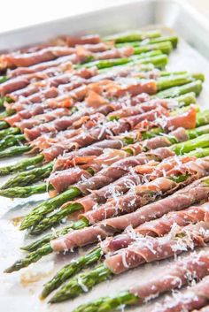 asparagus with prosciutto and parmesan cheese arranged on top