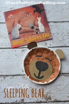 a paper plate with a bear on it next to a book about bears and other animals