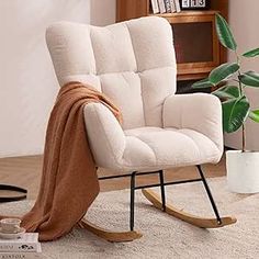 a rocking chair with a blanket draped over it