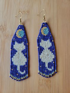 Colorful and stylish, these handwoven beaded earrings are great for anyone fun-loving (or cat-loving). They make the perfect, unique gift for moms, daughters, teens, tweens, secretaries, teachers, cat-lovers, pet-sitters, or anyone on your list. Sure to impress! Specs: Multi-colored seed beads Strong thread (minimally visible) Hanging length: about 4-inch drop length Width: about 1 inch Ear wires: hypoallergenic earring hook This listing is for one pair. As these are handmade, please slight variations may occur. Wearing while swimming or bathing may cause discoloration.  A smoke-free, LGBTQ+ friendly creator. Bead Fringe Earrings, Seed Bead Bracelet Patterns, Cat Moon, Bead Fringe, Cat Bead, Unique Gifts For Mom, Seed Bead Patterns, Earring Hook, Beaded Earrings Patterns