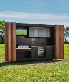 an outdoor entertainment center in the middle of a field