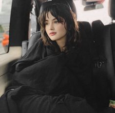 a woman sitting in the back seat of a car