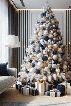 a white christmas tree with blue and gold ornaments in a living room decorated for the holidays