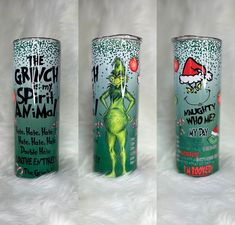 three cans of grinch energy drink on a white furnishing surface, one is green and the other is red