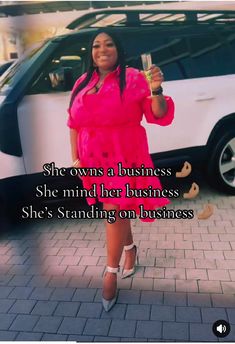 a woman standing in front of a white car holding a glass with the words she owns a business she mind her business she's standing on business