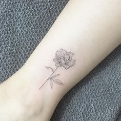 a single rose tattoo on the ankle