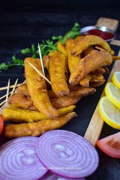 there are several different types of food on the table, including lemons and onion wedges