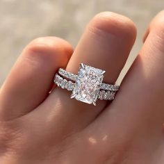 a woman's hand with a ring on it and a diamond in the middle