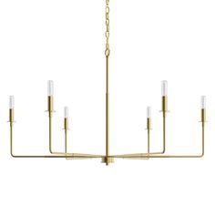 a brass chandelier with five lights hanging from the bottom, and four candles on each end