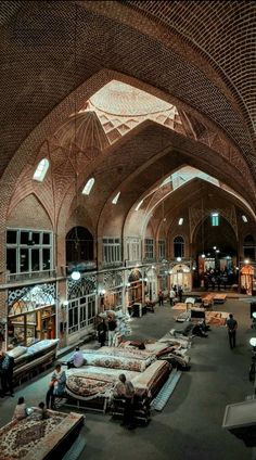 the inside of a large building with lots of furniture