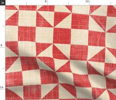 a red and white checkerboard pattern is shown on the fabric, which has been cut in half