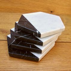 marble coasters stacked on top of each other in front of a wood flooring surface