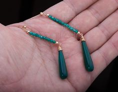 Two tier stone earring,long emerald bead string dangle earring,Nature green chalcedony earring,May birthday gift,anniversary gift,Valentine A pair of two tier natural stone beads / long rod 1. Stone : emerald and green chalcedony (natural gemstones) 2. Stone shape and size: top: a string of emerald bead about 3 mm wide and 37 mm in length, with gold ball stoppers bottom: long green chalcedony rod/club 34 x 7 mm with wire-wrapped cap 3. earring total length ~80 mm 5. wire and earring post: gold p Green Long Drop Jewelry For Gift, Elegant Green Onyx Earrings For Gift, Green Onyx Drop Earrings For Gifts, Green Onyx Gemstone Earrings As Gift, Elegant Green Gemstone Beaded Earrings, Green Onyx Dangle Earrings Gift, Green Onyx Earrings For May Birthstone Gift, Green Onyx Dangle Jewelry For Gift, Elegant Jade Earrings With Gemstone Beads