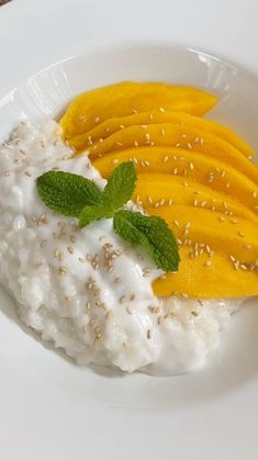 a white plate topped with fruit and yogurt