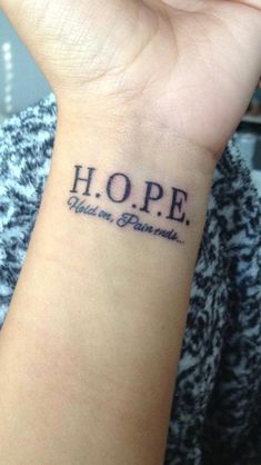 a woman's wrist tattoo with the words hope and an inscription that says hope