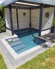 an outdoor pool with a gazebo and hot tub