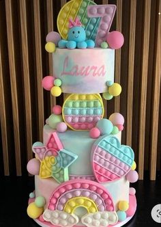 a three tiered cake with teddy bears on top