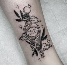 a woman's leg with a bottle tattoo on it