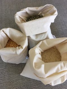 three bags filled with food sitting on top of a carpeted floor next to each other