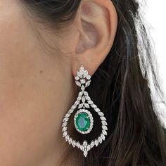 Indulge in luxury with these 18k Diamond and Emerald Drop Earrings. The earrings feature a total of 8.02 carats of emeralds surrounded by sparkling 9.10 carats of diamonds set in 18K white gold.  18K White Gold Diamond and Emerald Drop Earrings Condition: In good condition with some minor surface wear consistent with age. Length: 2.40 inches Width: 1.25 inches Metal: 18k White Gold Weight: 24 grams Diamond: 9.10 carats Emerald: 8.02 carats Emerald Drop Earrings, Emerald Earrings Drop, White Gold Diamonds, 9 And 10, Gold Diamond, Emerald, Diamonds, White Gold, Sparkle