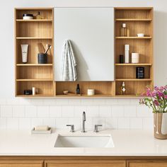 a bathroom sink sitting under a mirror next to a wooden shelf